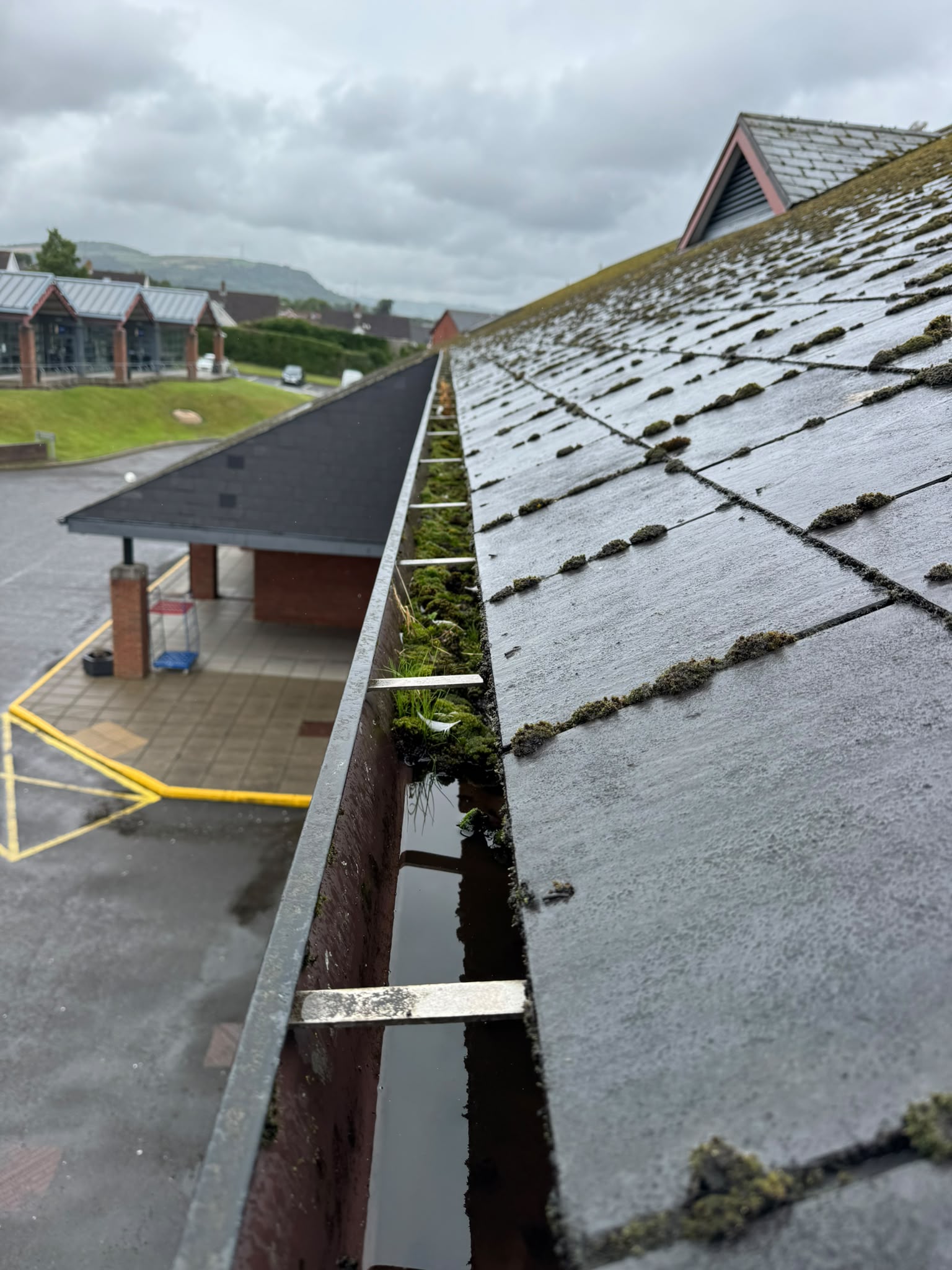 Hazelwood College school roofs and blocked gutters along the full run, seen from a cherry picker