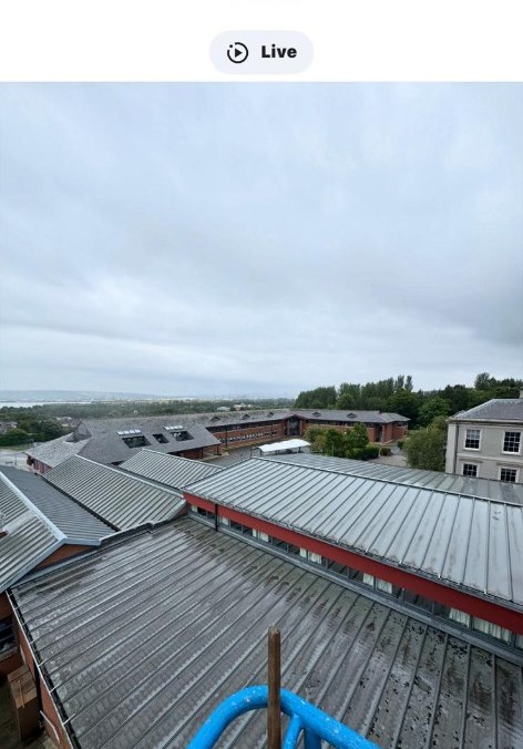 Multiple school rooftops at Hazelwood College seen from a cherry picker, showing the scale of the site